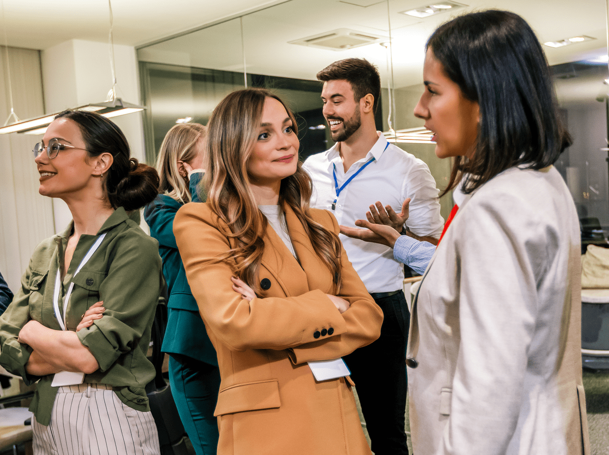 Two women engaged in a lively conversation at a social event.