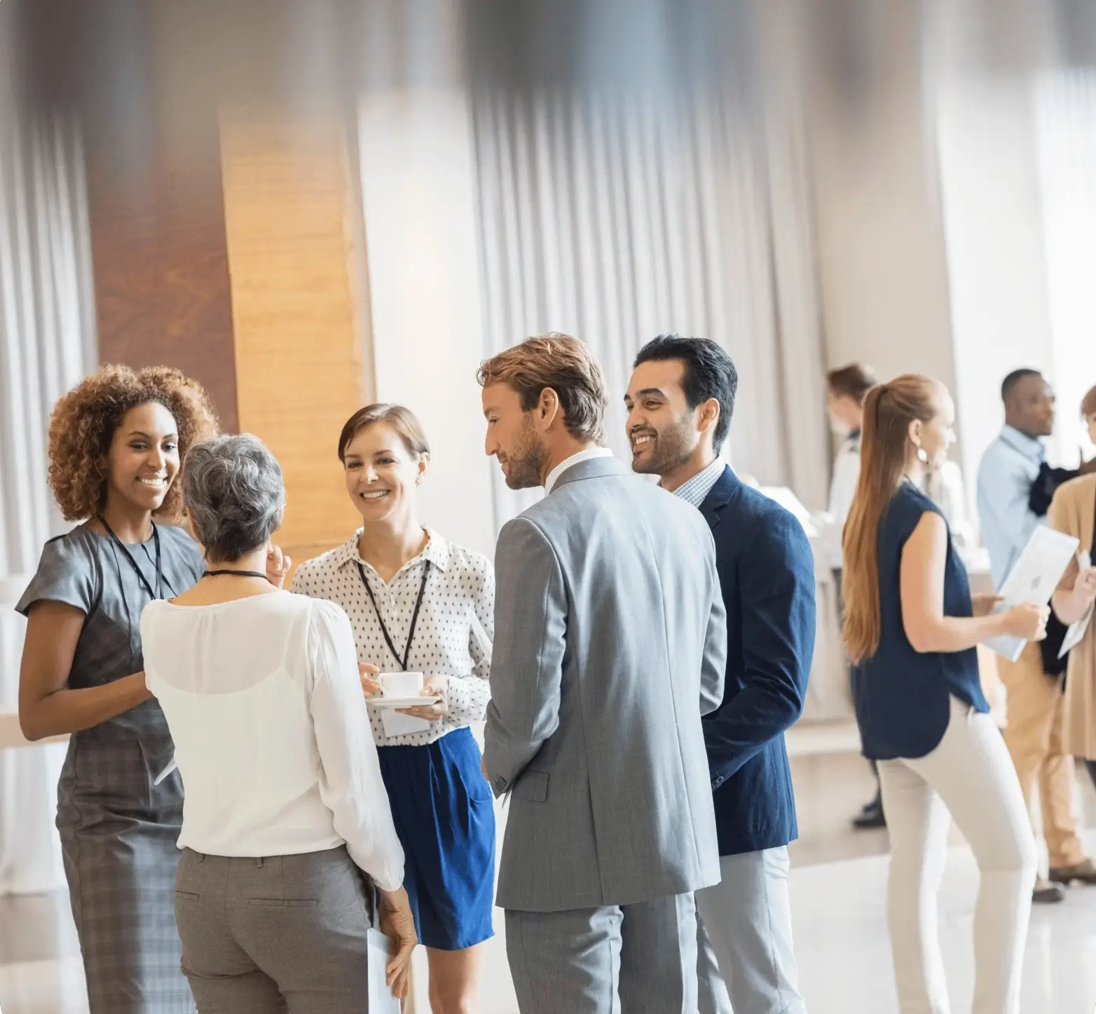 Professionals networking and discussing in a modern office setting.